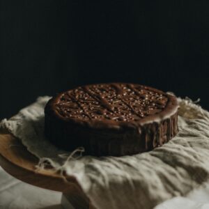 Delicious chocolate cake placed on rustic linen, ideal for dessert photography.