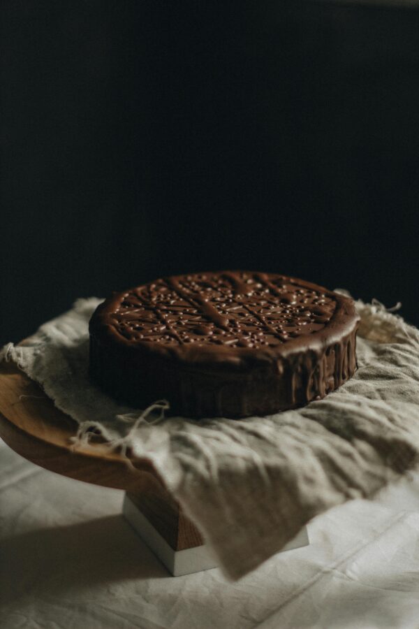 Delicious chocolate cake placed on rustic linen, ideal for dessert photography.