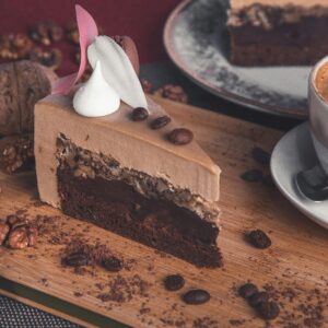 Enjoy a delicious slice of chocolate cake with coffee, perfect for dessert lovers.