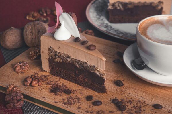 Enjoy a delicious slice of chocolate cake with coffee, perfect for dessert lovers.